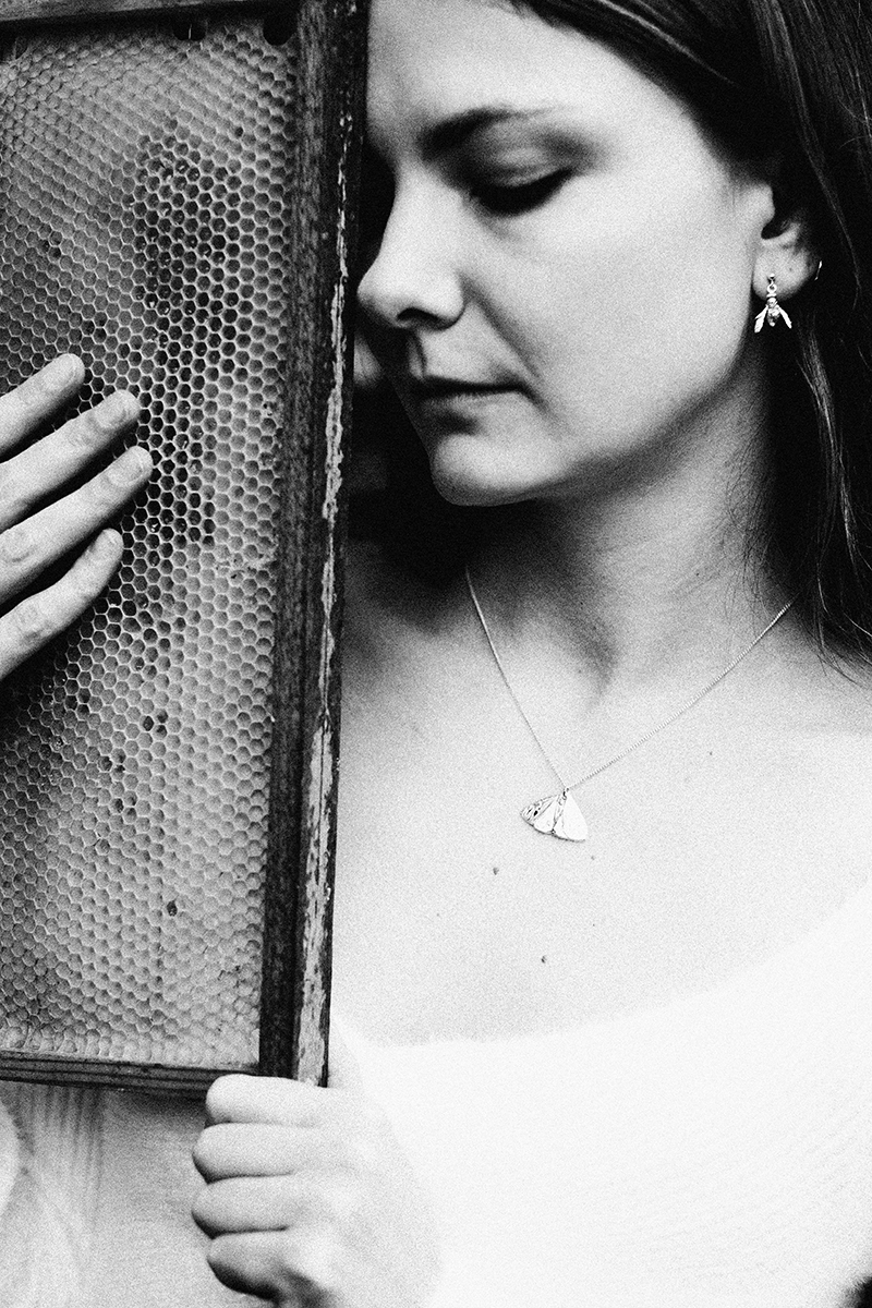 Wasp earrings on a model