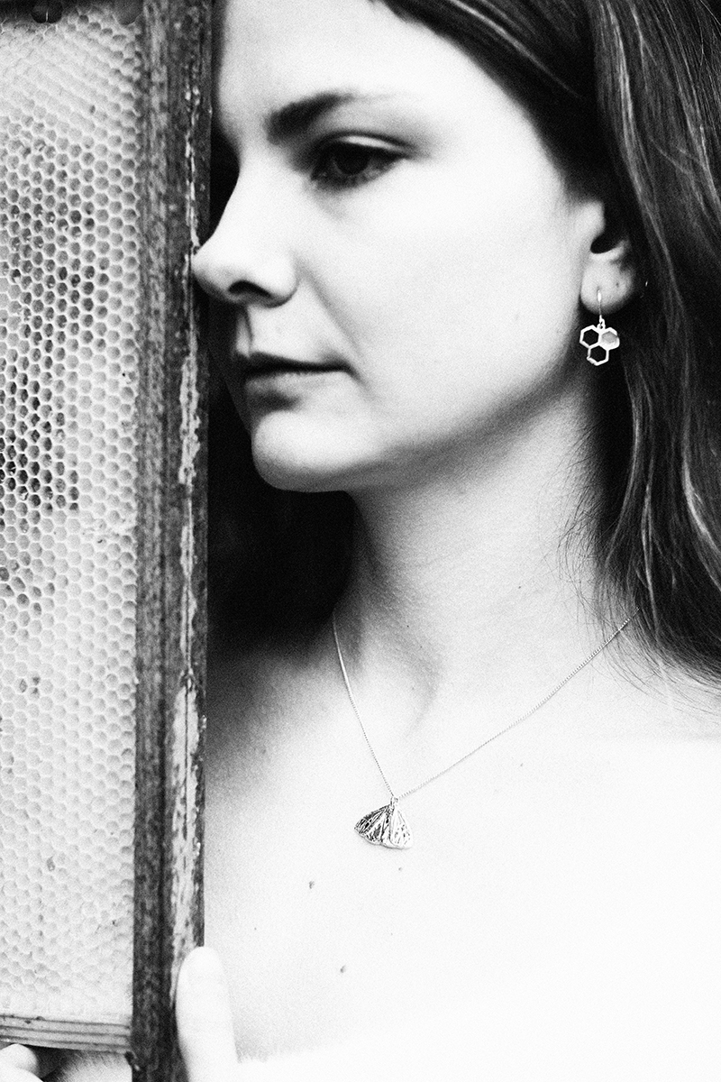 Wasp earrings on a model