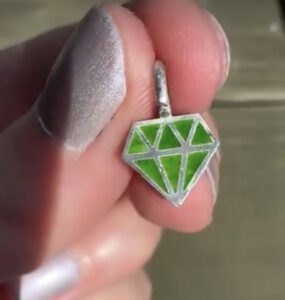 a sterling silver and enamel pendant in the form of a diamond - green